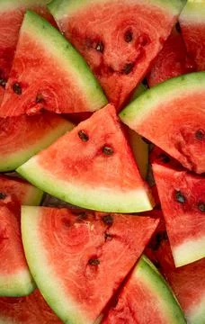 Background texture of pieces of watermelon in the form of triangles with bones Stock Photos