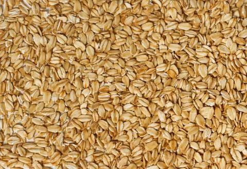 Background, texture of raw oatmeal close-up. Stock Photos