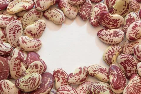 Background texture of red speckled October beans in an open circle Stock Photos