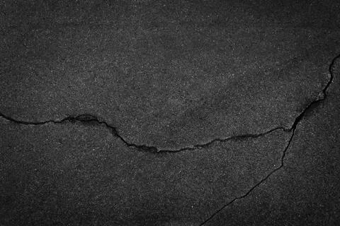 Background texture of rough cracked broken asphalt top view Stock Photos