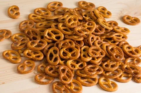 Background texture of salted savory mini pretzels in the traditional looped k Stock Photos