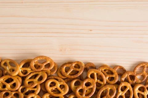 Background texture of salted savory mini pretzels in the traditional looped k Stock Photos