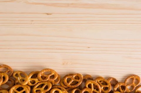 Background texture of salted savory mini pretzels in the traditional looped k Stock Photos