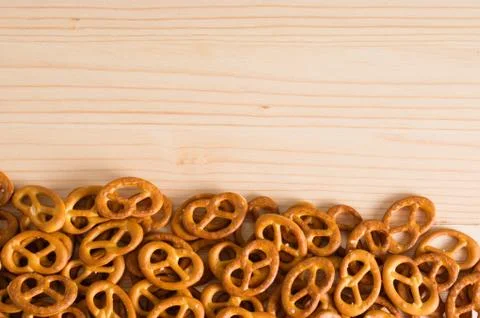 Background texture of salted savory mini pretzels in the traditional looped k Stock Photos