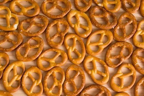 Background texture of salted savory mini pretzels in the traditional looped k Stock Photos