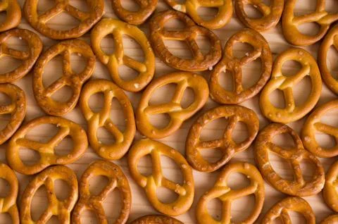 Background texture of salted savory mini pretzels in the traditional looped k Stock Photos