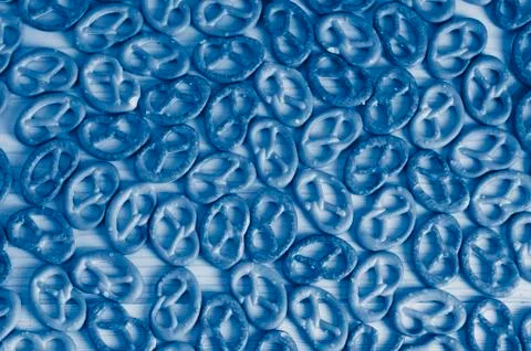 Background texture of salted savory mini pretzels in the traditional looped k Stock Photos