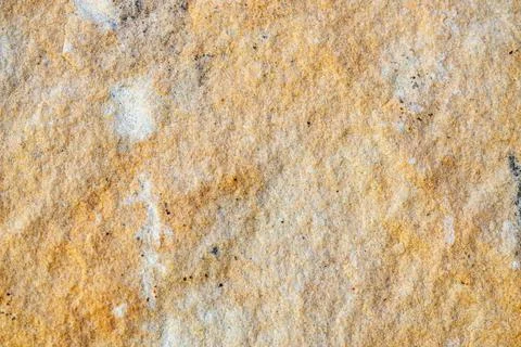 Background texture of sandstone stone surface, rough chopped orange stone for Stock Photos