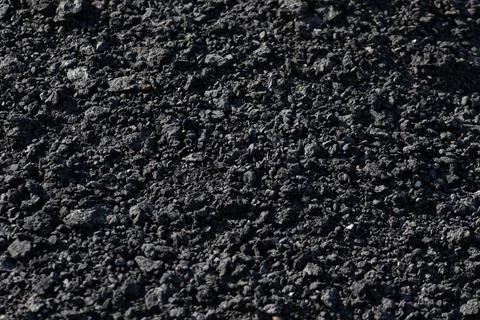 The background is the texture of small black fragmented stones in the form Foto stock