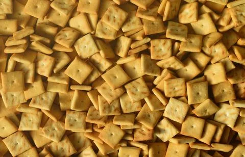 Background texture of small edible squares baked from dough and sprinkled with Fotos de archivo