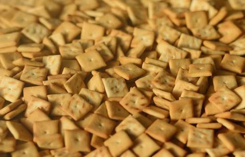 Background texture of small edible squares baked from dough and sprinkled with Stock Photos