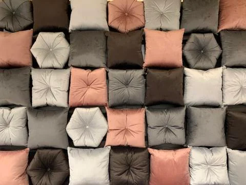 Background texture: small sleeping pillows. Soft pillows for wall decor. Room Stock Photos