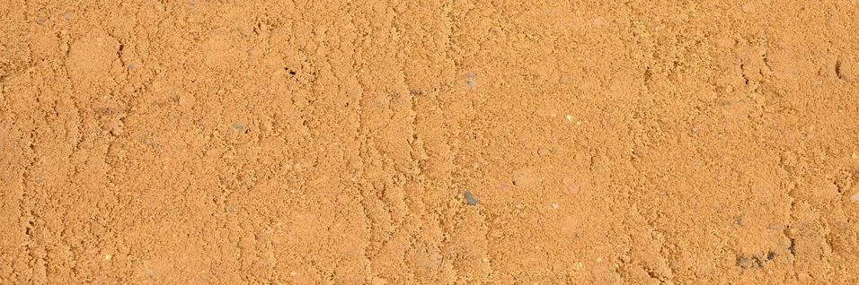 Background texture from the smooth surface of the sand. top view. banner Stock Photos