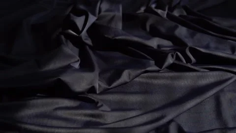 A background texture of soft black fabric textile material reverse moving. Stock Footage 87710821