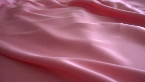 A background texture of soft pink fabric textile material reverse moving. Video stock 87713942