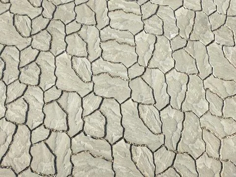 Background texture of stone pavement tiles with small cracks at the joints Stock Photos