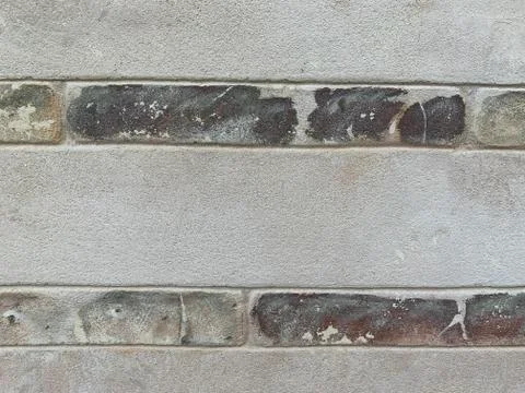 Background texture: stone wall of the building. Painted brick and concrete wa Stock Photos