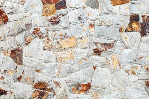 Background texture of stone wall made of colorful stones Stock Photos