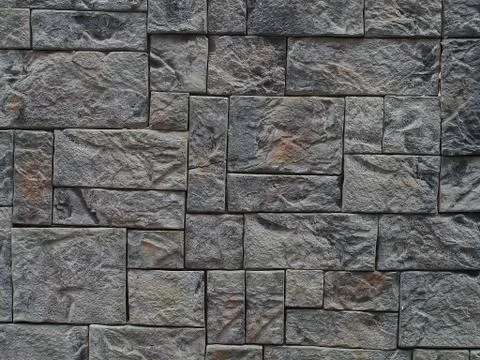 Background texture of stone wall. Natural stone, a wall of natural stone. Stock Photos