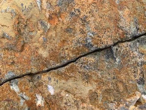 Background texture: the structure of a large stone. Granite boulder close up. Stock Photos