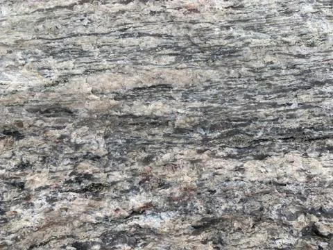 Background texture: the structure of a large stone. Granite boulder close up. Stock Photos