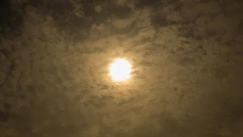 Background, texture. Sun bright behind soft clouds. Stock Photos