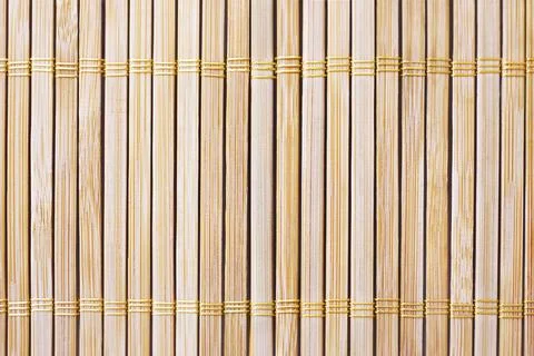 Background texture of sushi rolling mat of the natural bamboo wood Stock Photos