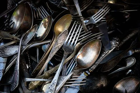 Background texture of tea silver teaspoons and cutlery. Shiny golden tea spoo Stock Photos