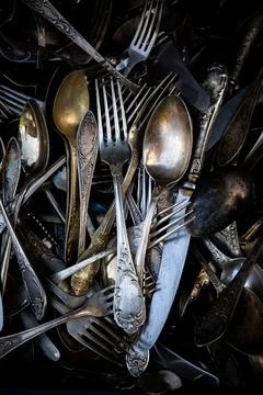 Background texture of tea silver teaspoons and cutlery. Shiny golden tea spoo Stock Photos