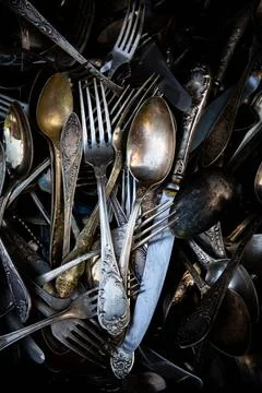 Background texture of tea silver teaspoons and cutlery. Shiny golden tea spoo Stock Photos