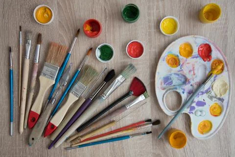 Background, texture. Top view of the artist's easel, gouache and brushes Stock Photos