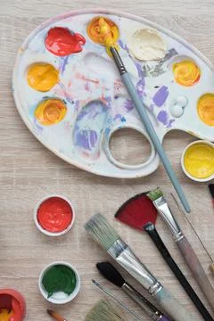 Background, texture. Top view of the artist's easel, gouache and brushes Stock Photos