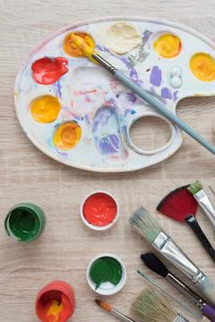 Background, texture. Top view of the artist's easel, gouache and brushes Stock Photos