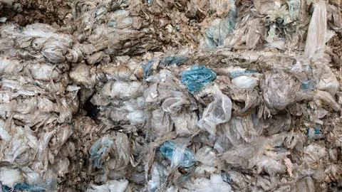 Background texture of used plastic bags and packaging stored at plant for sor Stock Photos