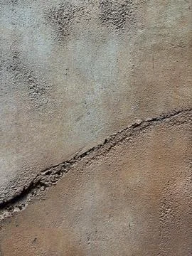 Background texture of wall with coarse stucco or concrete with large crack Stock Photos
