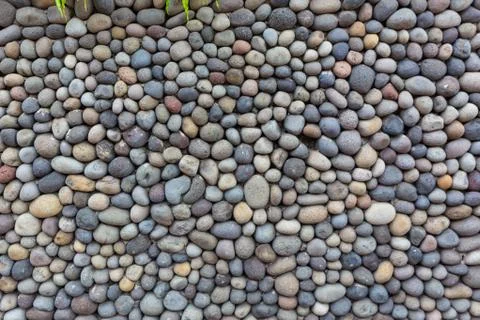 Background texture, wall consisting of small river stones Foto stock