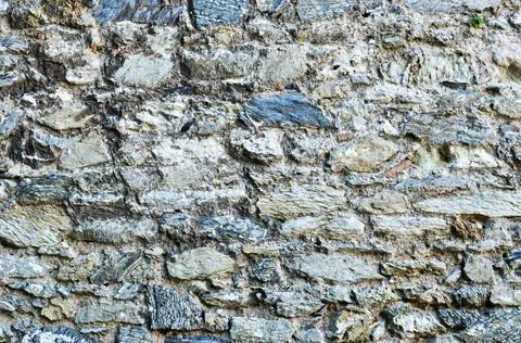 Background, texture. A wall of flat stones and cement. Stock Photos