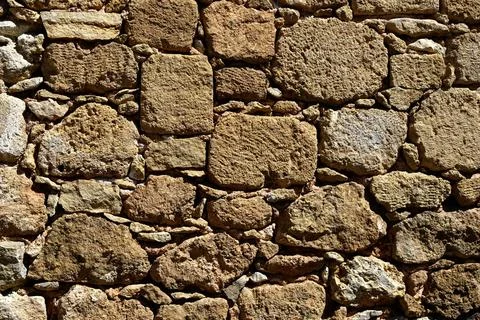 Background texture of warm coloured stone blocks in a wall Stock Photos