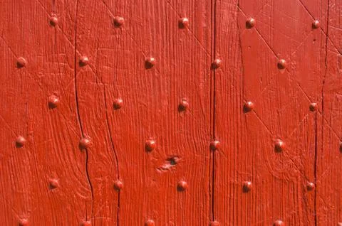 Background texture weathered red door with nail pattern Stock Photos