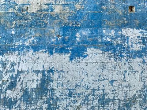 Background texture with white dirty wall and craked blue paint. Stock Photos