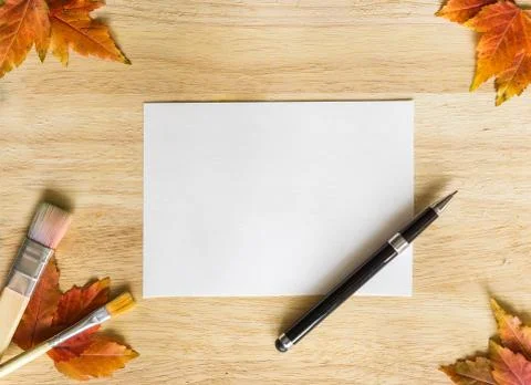 Background texture with wooden table and autumnal leaves. Stock Photos