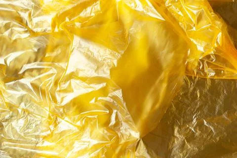 Background, texture from yellow recyclable polyethylene. Eco, zero waste, alt Stock Photos