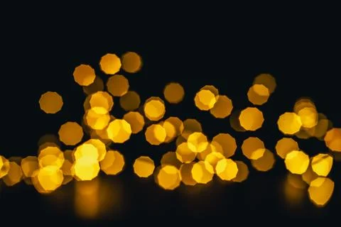 Background, texture. Yellow round bokeh stars on black background Stock Photos
