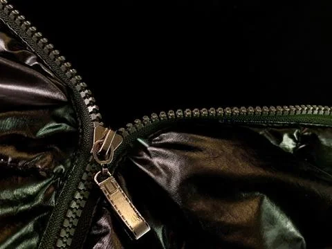 Background texture: zipper in a jacket on a black background. Opened lock on  Stock Photos