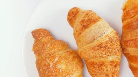 Background of three French croissants making a circular motion Stock Footage 91580853