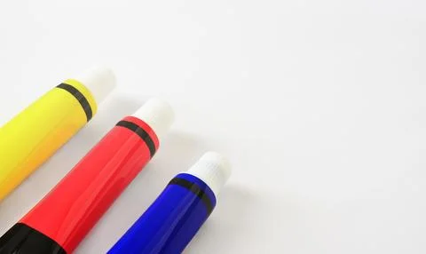 Background with three paint tubes in red, blue, and yellow, copy space Stock Photos
