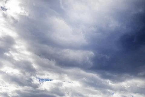 Background of thunderclouds before rain with a patch of blue sky 스톡 사진