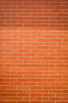 The background of the tiles is in the form of orange brickwork Stock Photos