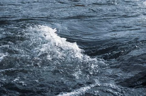 Background, top view, rapid flow river with dark blue water and white foam wa Stock Photos