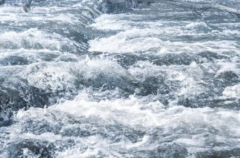 Background, top view, rapid flow river with dark blue water and white foam wa Stock Photos